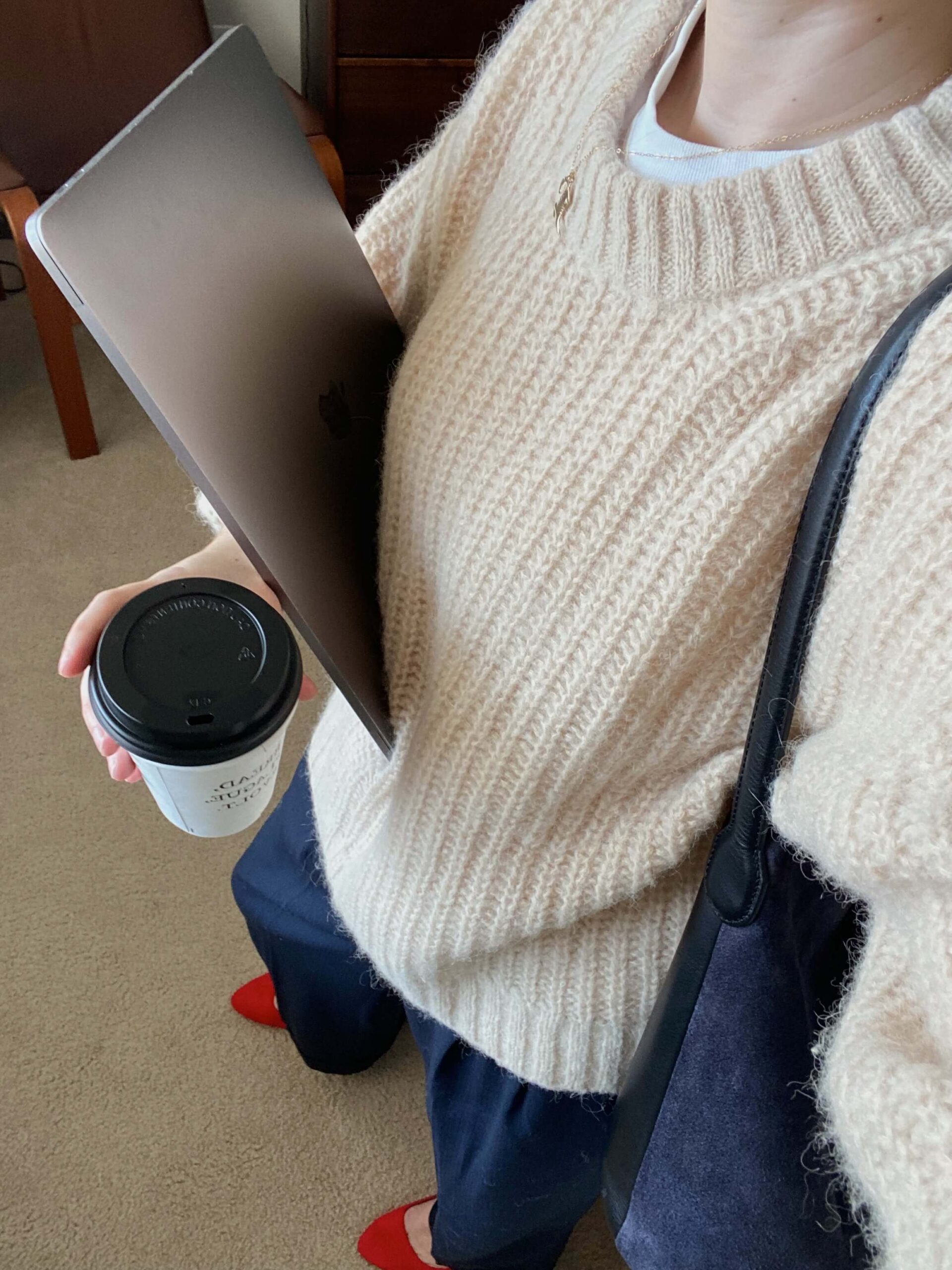 woman holding a laptop and coffee